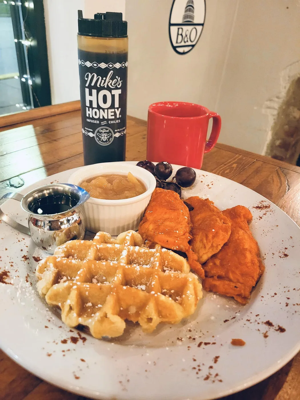 Chicken and waffles with Mike's Hot Honey on the table at The Water Main Grille